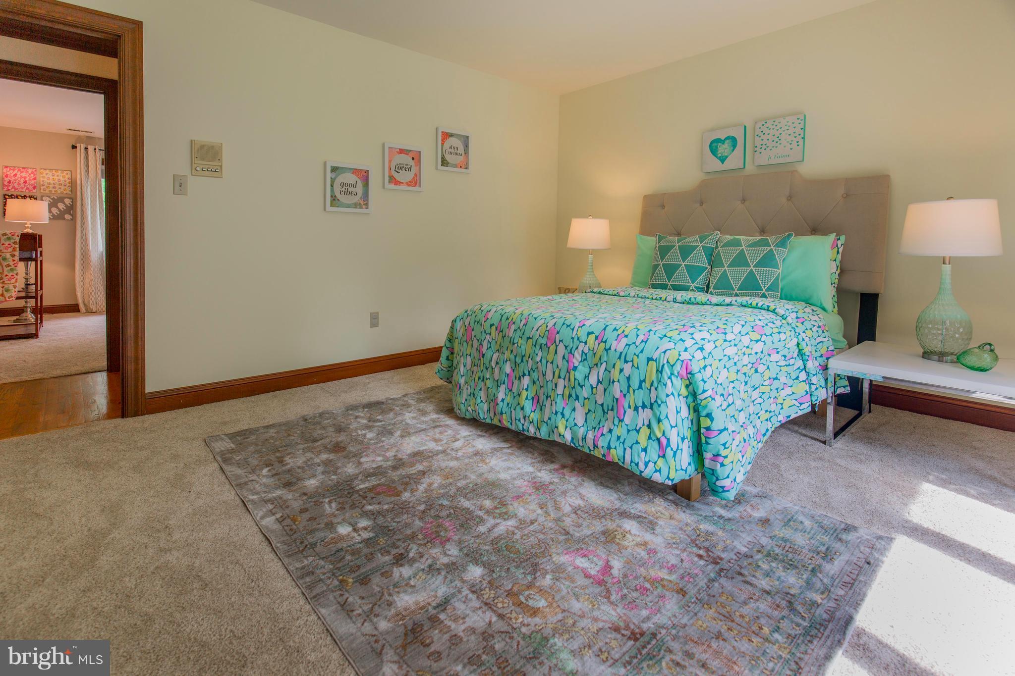 610 Bryants Nursery Road Silver Spring, MD 20905 - Photo 23 of 30 a bedroom with a bed and a lamp on table