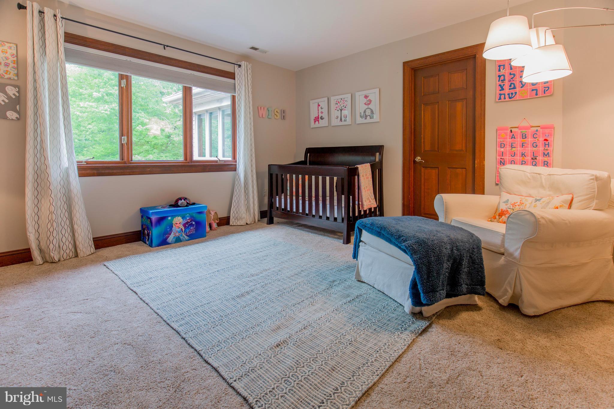 610 Bryants Nursery Road Silver Spring, MD 20905 - Photo 24 of 30 a bedroom with a bed and a chandelier