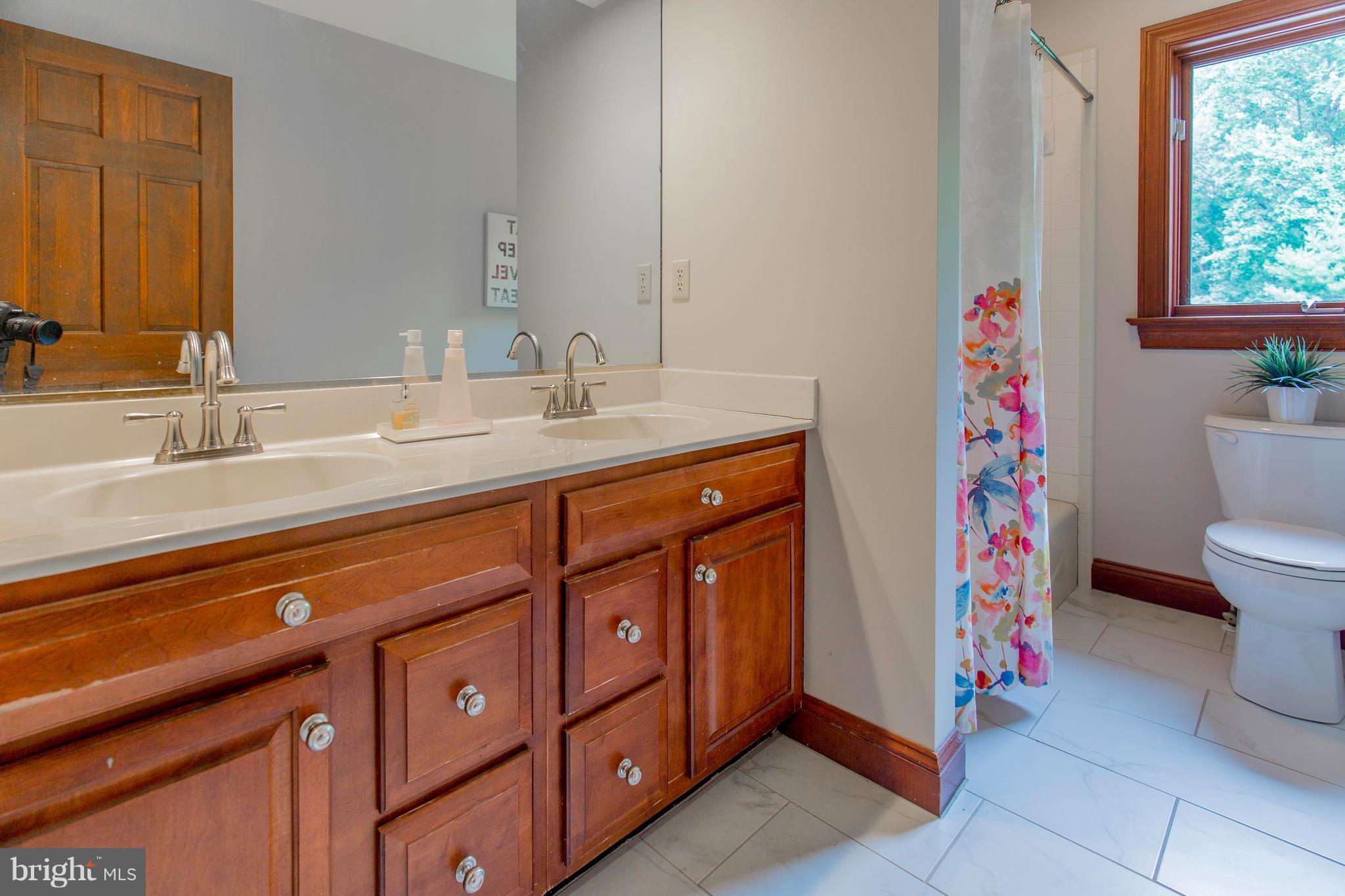 610 Bryants Nursery Road Silver Spring, MD 20905 - Photo 25 of 30 a spacious bathroom with a sink and a mirror