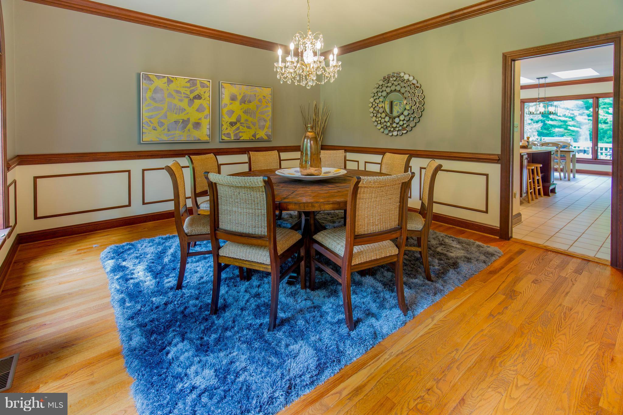 610 Bryants Nursery Road Silver Spring, MD 20905 - Photo 9 of 30 a dining room with furniture a rug and a chandelier