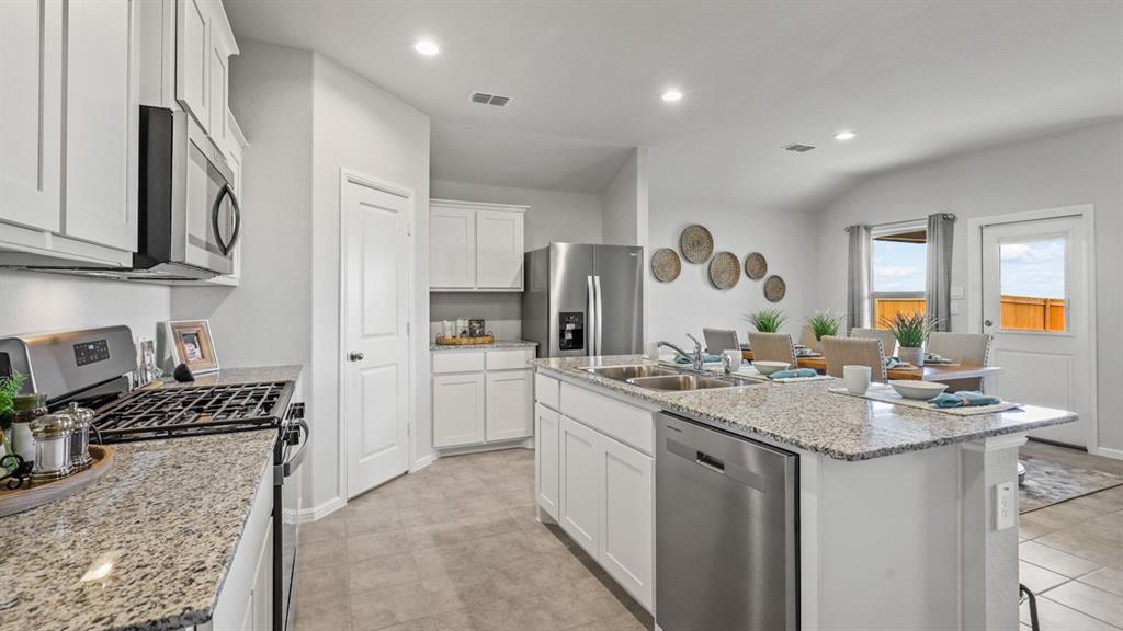 a kitchen with a sink stove and cabinets