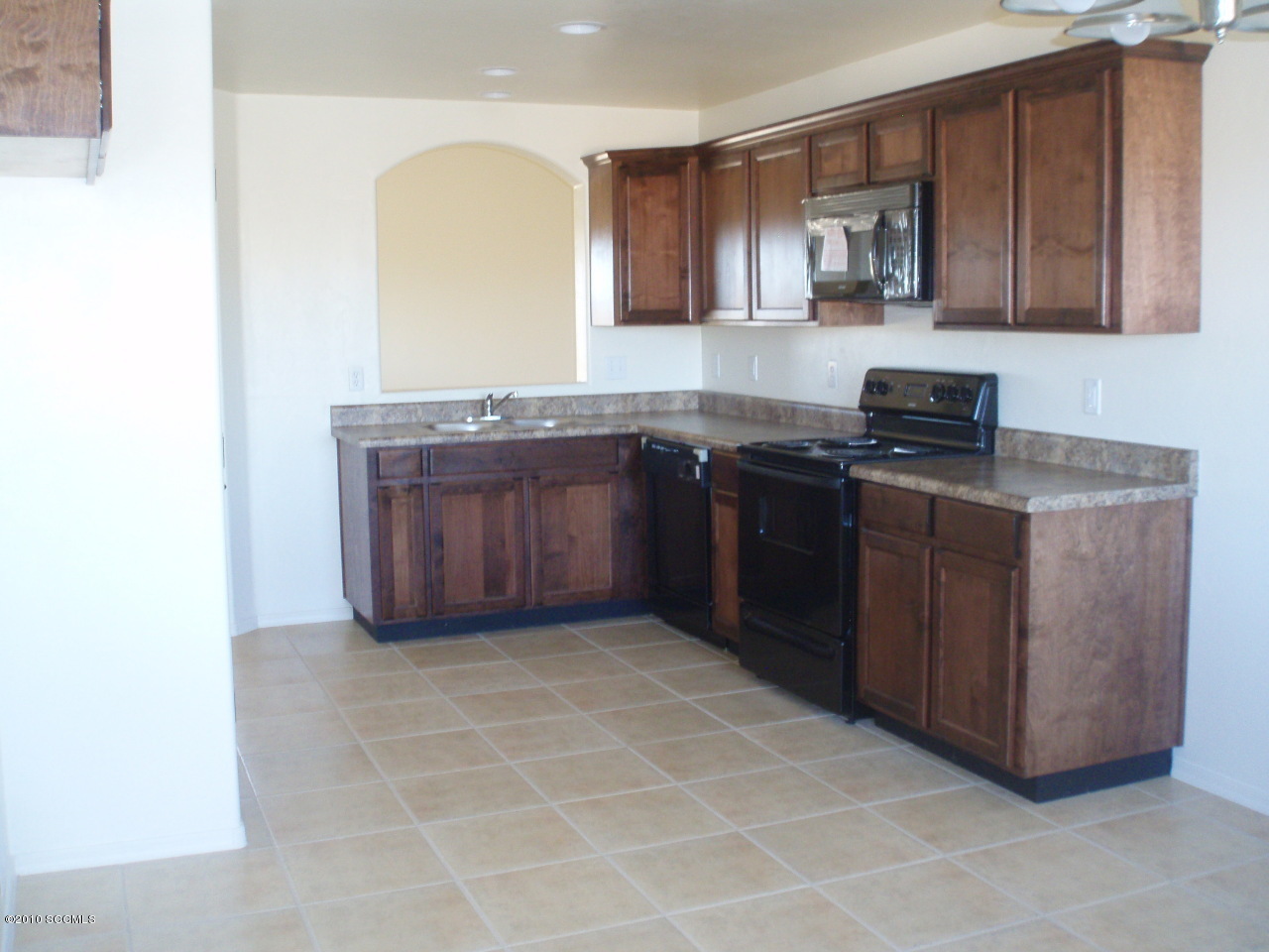 234 Via Espina Rio Rico, AZ 85648 - Photo 4 of 6 a kitchen with stainless steel appliances granite countertop a stove a sink and a microwave