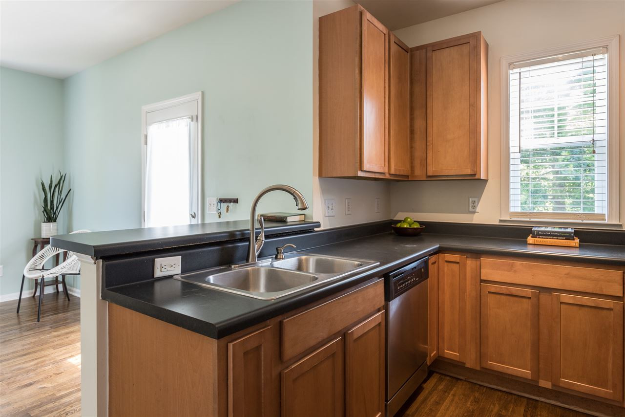 233 Cooke Street Raleigh, NC 27601 - Photo 9 of 27 And, again, that space the kitchen breakfast bar opens to also has a back door leading out to...