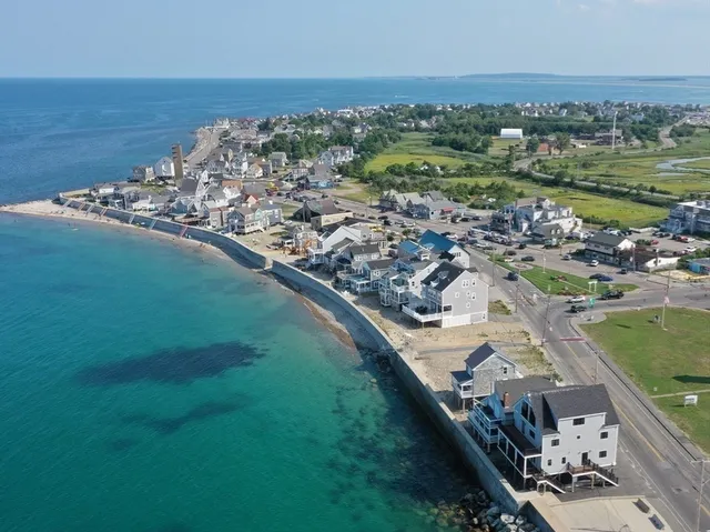 an aerial view of a house with garden space and ocean view