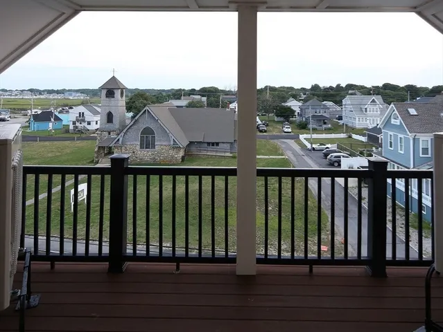 a balcony with wooden floor and city view