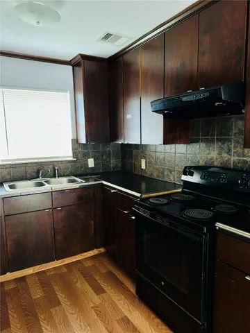 a kitchen with a sink and a stove