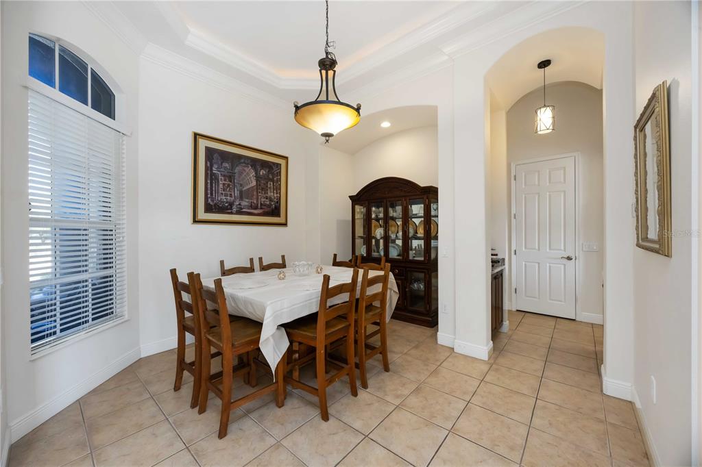 14806 Bowfin Terrace Lakewood Ranch, FL 34202 - Photo 14 of 95 a view of a dining room with furniture and chandelier fan