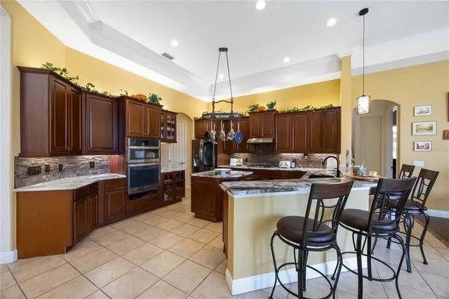 a bedroom with a bed table chair and a window