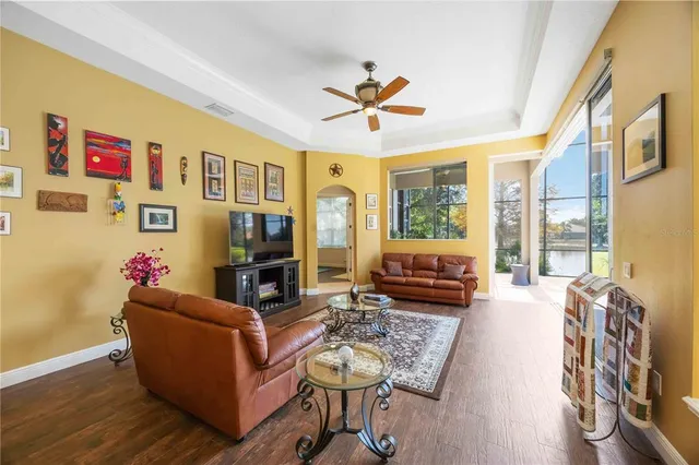 a spacious bedroom with a bed a dresser and with couch