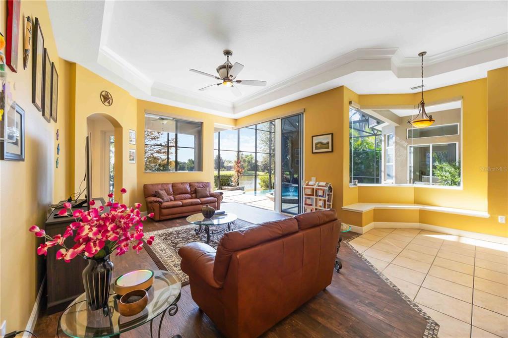 14806 Bowfin Terrace Lakewood Ranch, FL 34202 - Photo 31 of 95 a living room with furniture and a chandelier