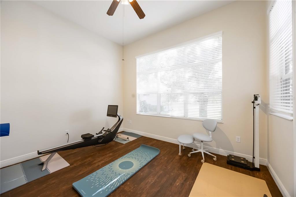 14806 Bowfin Terrace Lakewood Ranch, FL 34202 - Photo 35 of 95 a room with gym equipment and windows