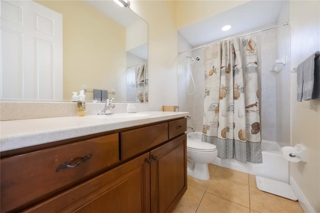 14806 Bowfin Terrace Lakewood Ranch, FL 34202 - Photo 39 of 95 a bathroom with a double vanity sink toilet and shower