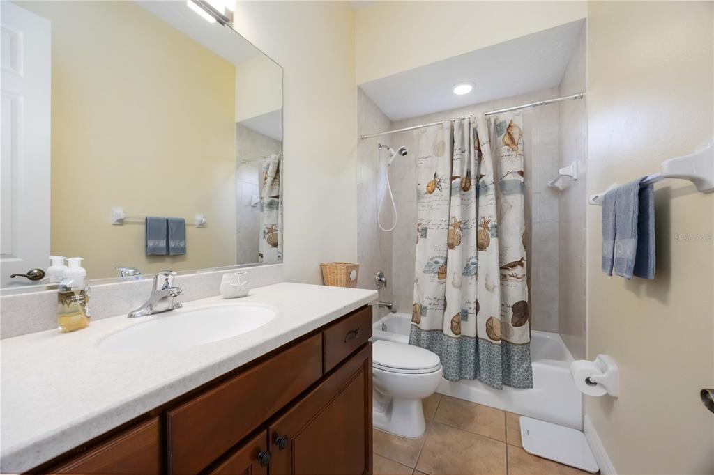 14806 Bowfin Terrace Lakewood Ranch, FL 34202 - Photo 40 of 95 a bathroom with a double vanity sink toilet and shower