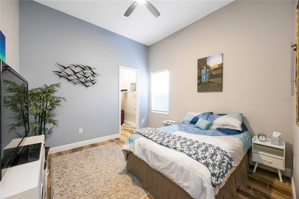 14806 Bowfin Terrace Lakewood Ranch, FL 34202 - Photo 46 of 95 a bedroom with a bed and a potted plant