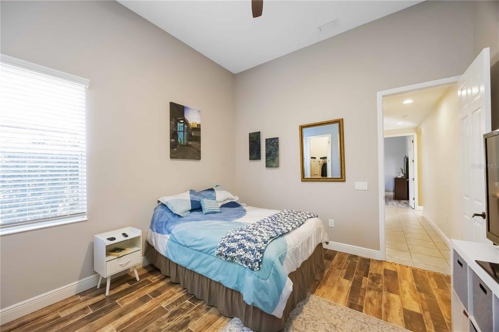 14806 Bowfin Terrace Lakewood Ranch, FL 34202 - Photo 47 of 95 a bedroom with a bed and wooden floor