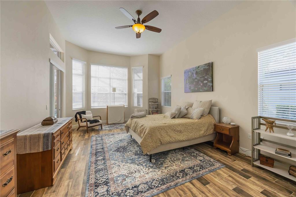 14806 Bowfin Terrace Lakewood Ranch, FL 34202 - Photo 49 of 95 a bedroom with a bed a couch and large window