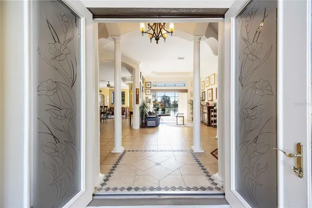a view of a dining room with furniture and chandelier fan