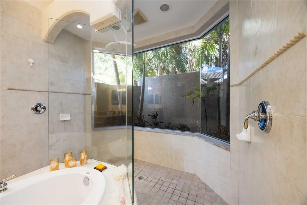14806 Bowfin Terrace Lakewood Ranch, FL 34202 - Photo 57 of 95 a bathroom with a bathtub and a shower