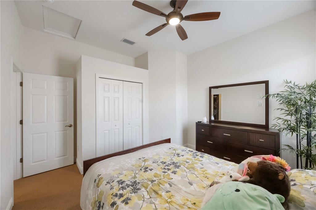 14806 Bowfin Terrace Lakewood Ranch, FL 34202 - Photo 62 of 95 a bedroom with a bed and a dresser