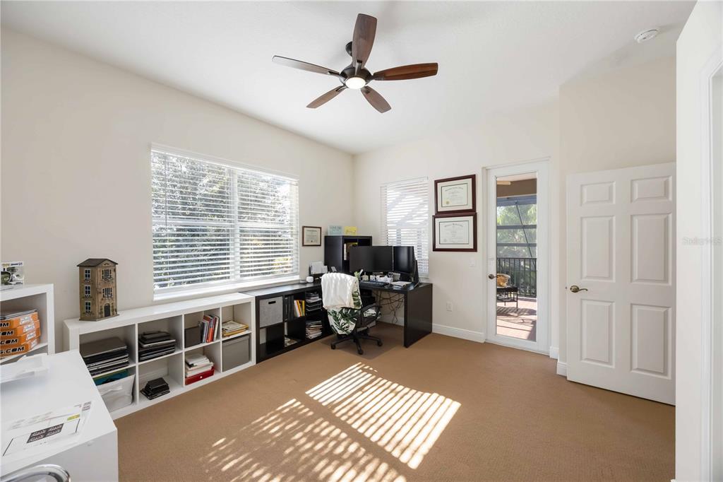 14806 Bowfin Terrace Lakewood Ranch, FL 34202 - Photo 66 of 95 a living room with furniture a dining table and a window