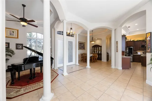 a large white bed in a room next to a window
