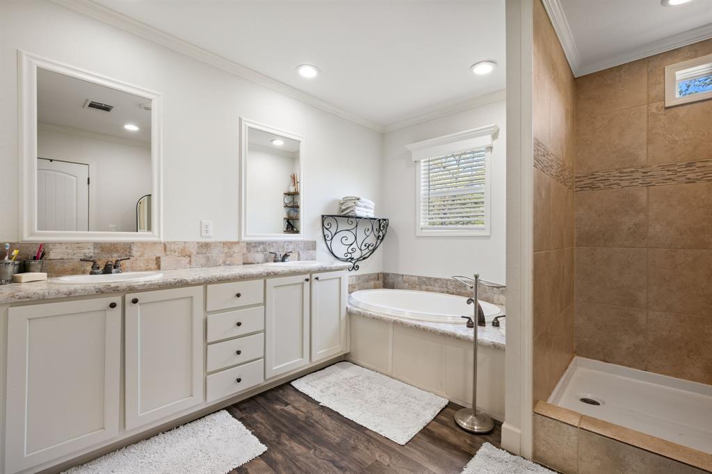 660 Deer Trail Gordon, TX 76453 - Photo 12 of 40 a bathroom with a tub sink and mirror