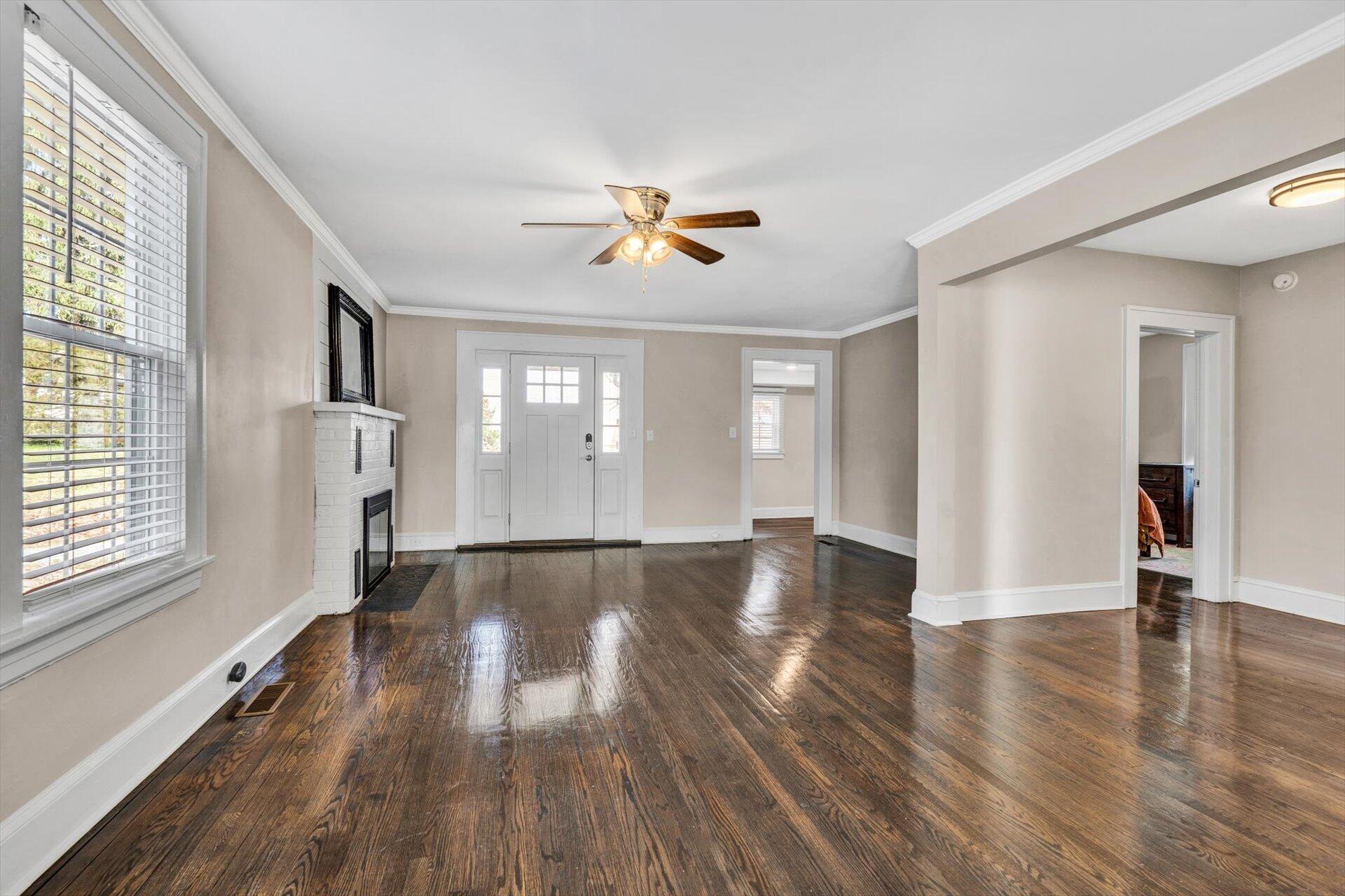 3718 Keagy Road Southwest Roanoke, VA 24018 - Photo 3 of 22 an empty room with wooden floor and windows