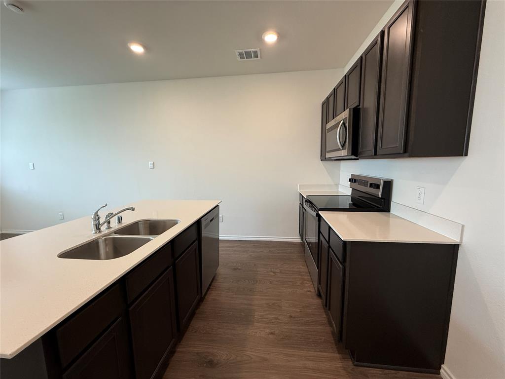 6114 Holly Spg Road Princeton, TX 75407 - Photo 2 of 7 a kitchen with a sink and a refrigerator