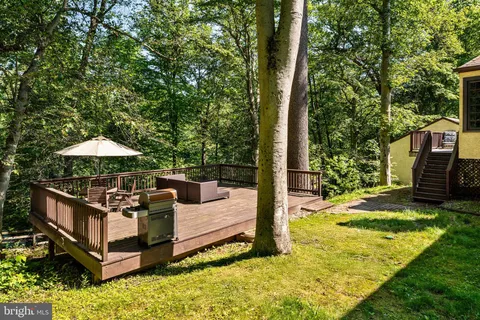 a view of a wooden deck with a yard