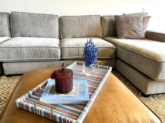 a large kitchen with granite countertop a stove a sink a dining table and chairs with wooden floor