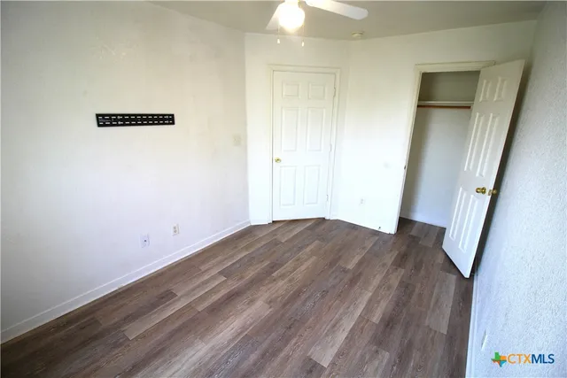 an empty room with wooden floor
