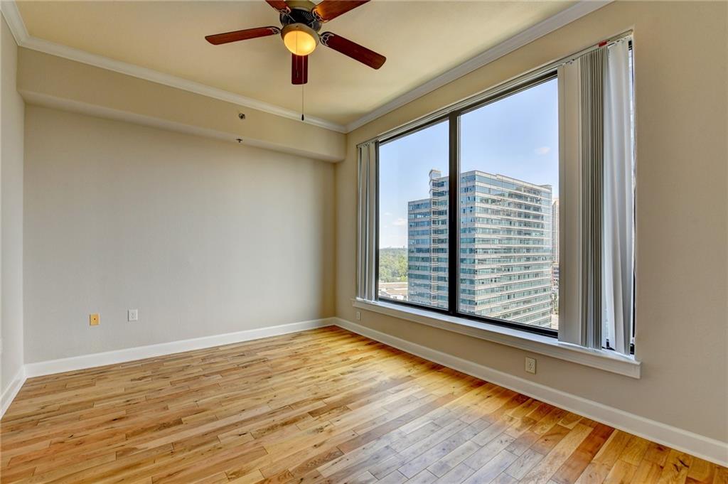 3445 Stratford Road Northeast, Unit 2106 Atlanta, GA 30326 - Photo 12 of 44 a view of an empty room with a window and wooden floor