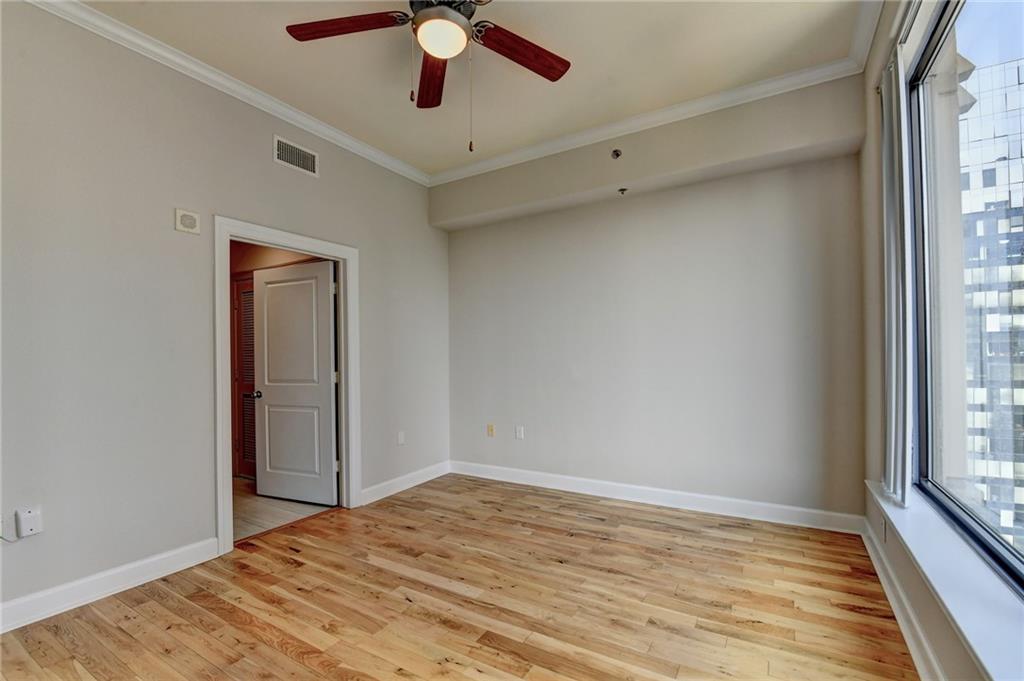 3445 Stratford Road Northeast, Unit 2106 Atlanta, GA 30326 - Photo 14 of 44 a view of empty room with wooden floor and fan