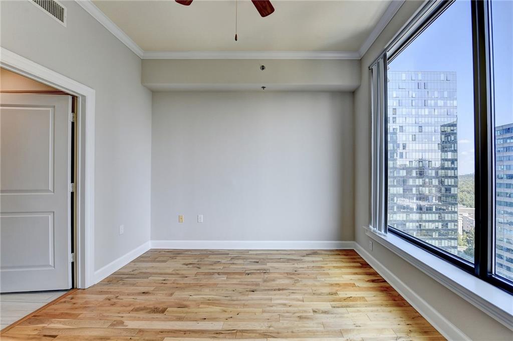 3445 Stratford Road Northeast, Unit 2106 Atlanta, GA 30326 - Photo 15 of 44 a view of an empty room with window and wooden floor