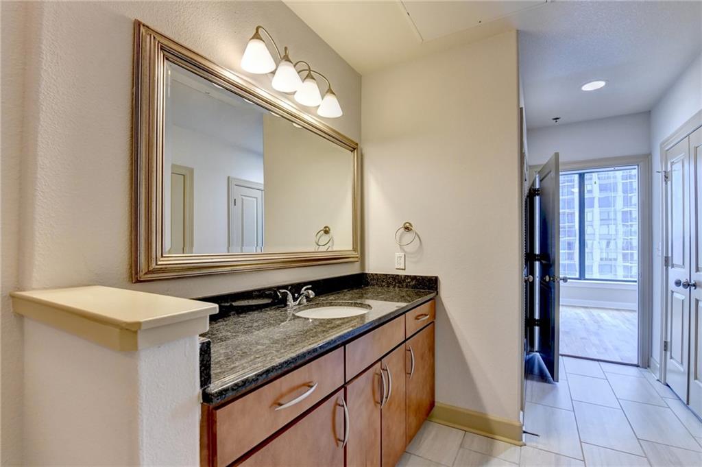 3445 Stratford Road Northeast, Unit 2106 Atlanta, GA 30326 - Photo 17 of 44 a bathroom with a sink and a mirror
