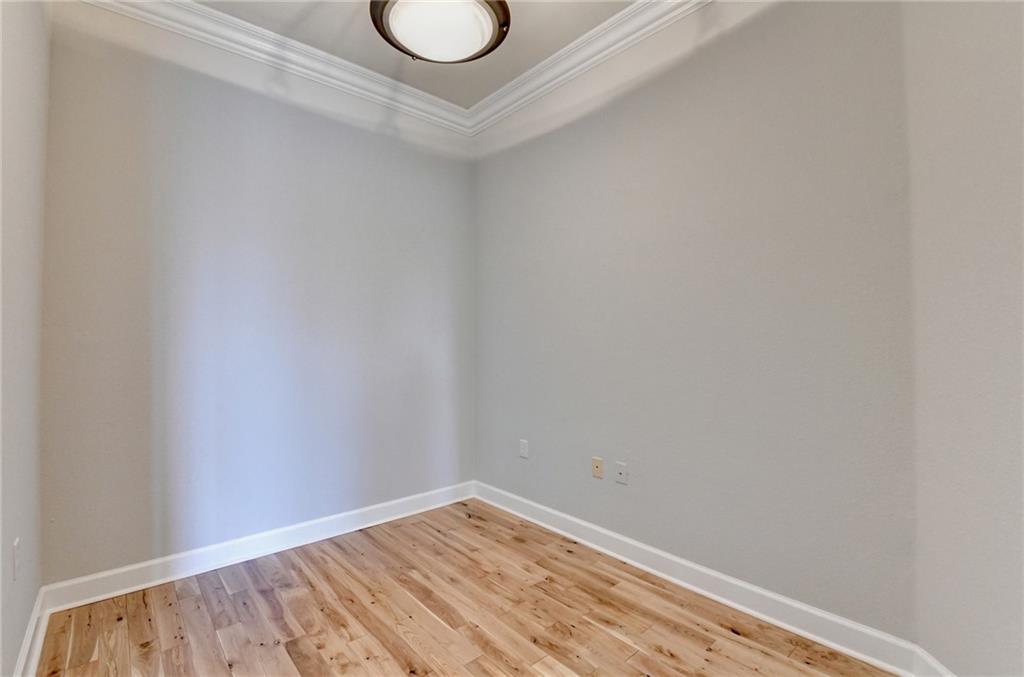 3445 Stratford Road Northeast, Unit 2106 Atlanta, GA 30326 - Photo 20 of 44 a view of a room with wooden floor and a window