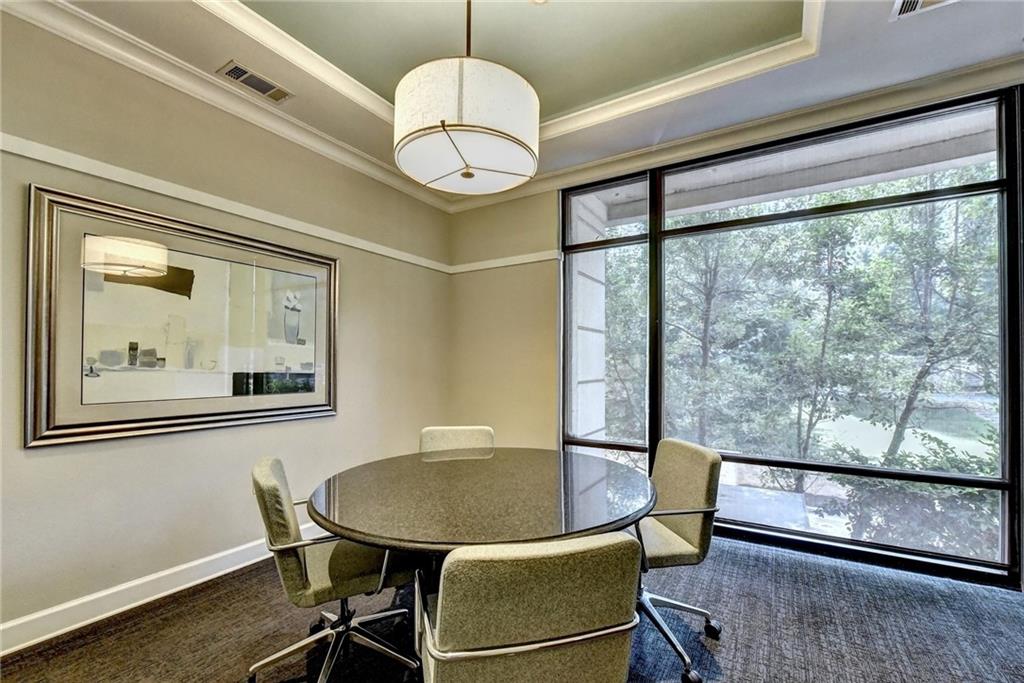 3445 Stratford Road Northeast, Unit 2106 Atlanta, GA 30326 - Photo 36 of 44 a view of a dining room with furniture window and wooden floor