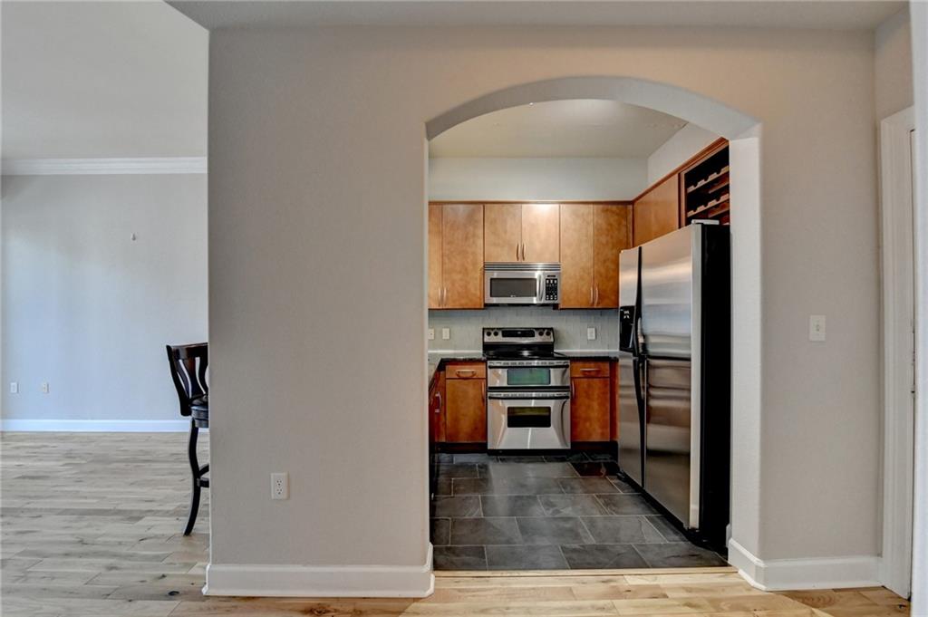 3445 Stratford Road Northeast, Unit 2106 Atlanta, GA 30326 - Photo 4 of 44 a kitchen with stainless steel appliances granite countertop a refrigerator and a stove