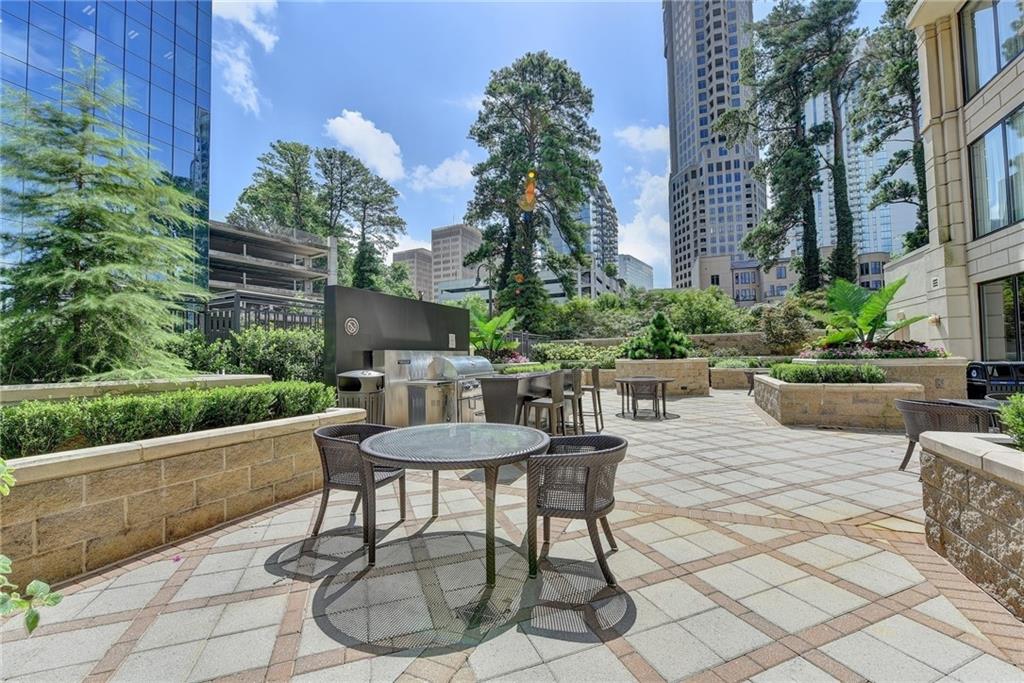 3445 Stratford Road Northeast, Unit 2106 Atlanta, GA 30326 - Photo 41 of 44 a view of a patio with a table and chairs and potted plants