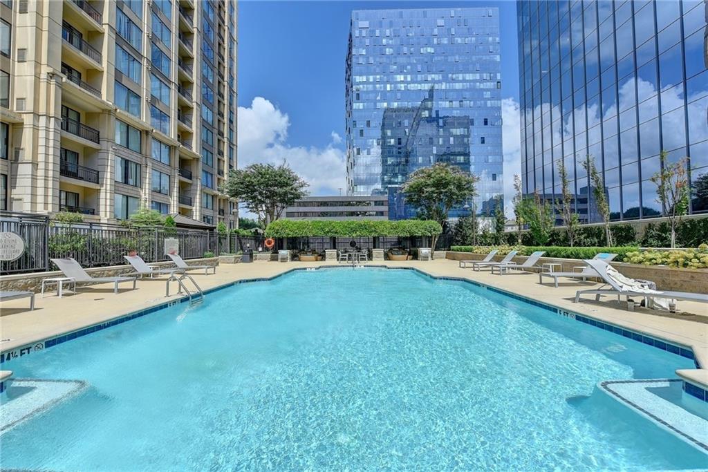 3445 Stratford Road Northeast, Unit 2106 Atlanta, GA 30326 - Photo 42 of 44 a swimming pool with outdoor seating and yard