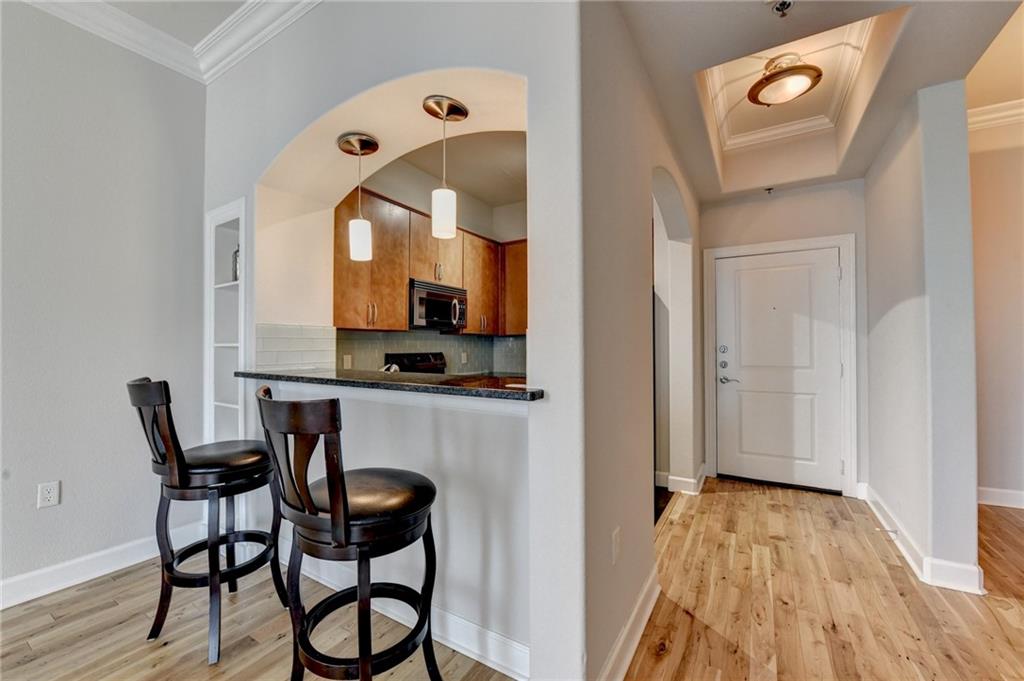 3445 Stratford Road Northeast, Unit 2106 Atlanta, GA 30326 - Photo 7 of 44 a dining room with furniture and wooden floor
