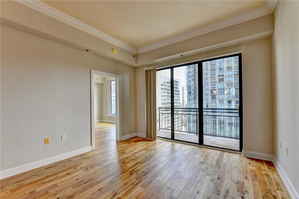 3445 Stratford Road Northeast, Unit 2106 Atlanta, GA 30326 - Photo 8 of 44 a view of an empty room with wooden floor and a window