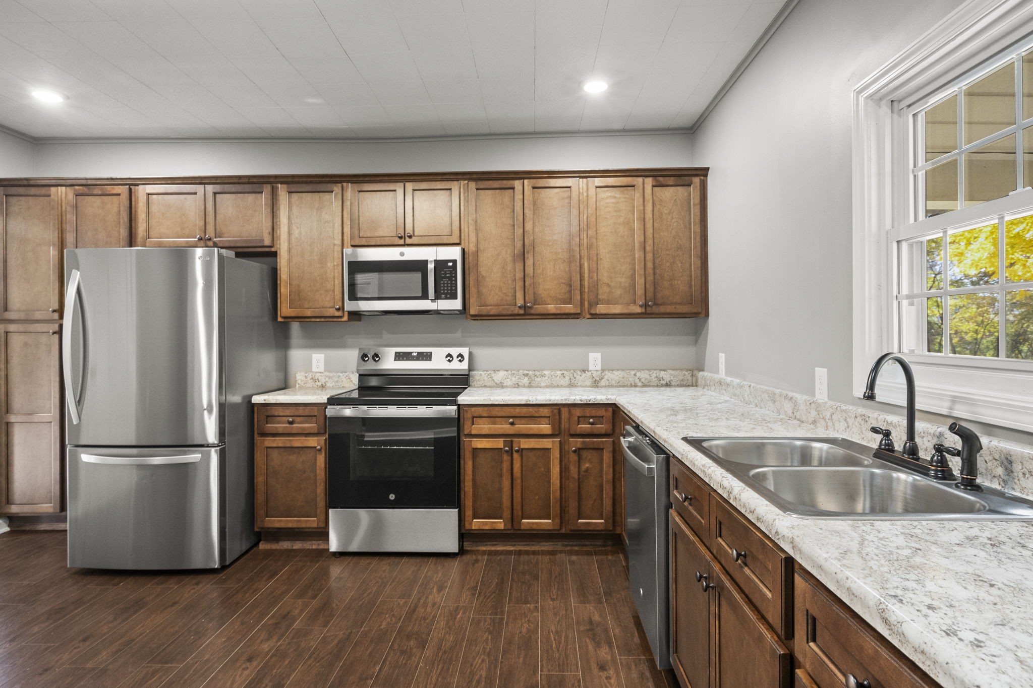 6081 Lakeview Road Springfield, TN 37172 - Photo 17 of 41 a kitchen with granite countertop stainless steel appliances a sink cabinets and a window