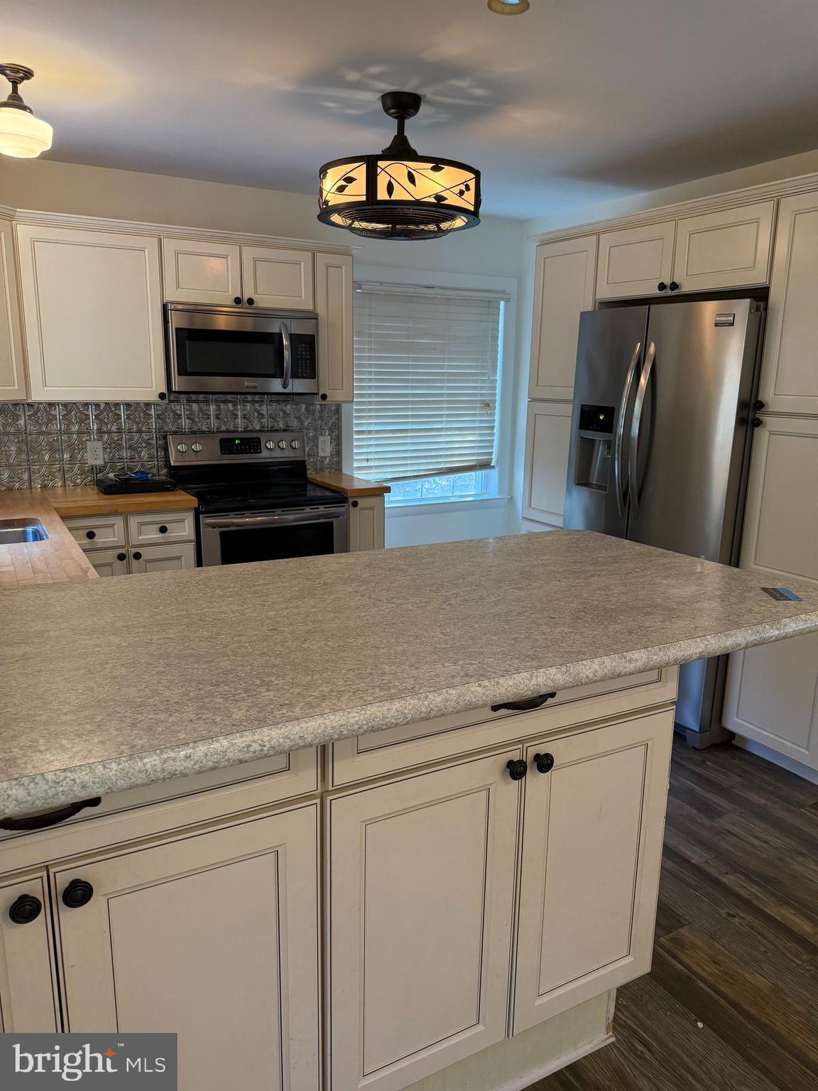 24975 Kruger Road Georgetown, DE 19947 - Photo 4 of 19 a kitchen with stainless steel appliances a stove microwave and refrigerator