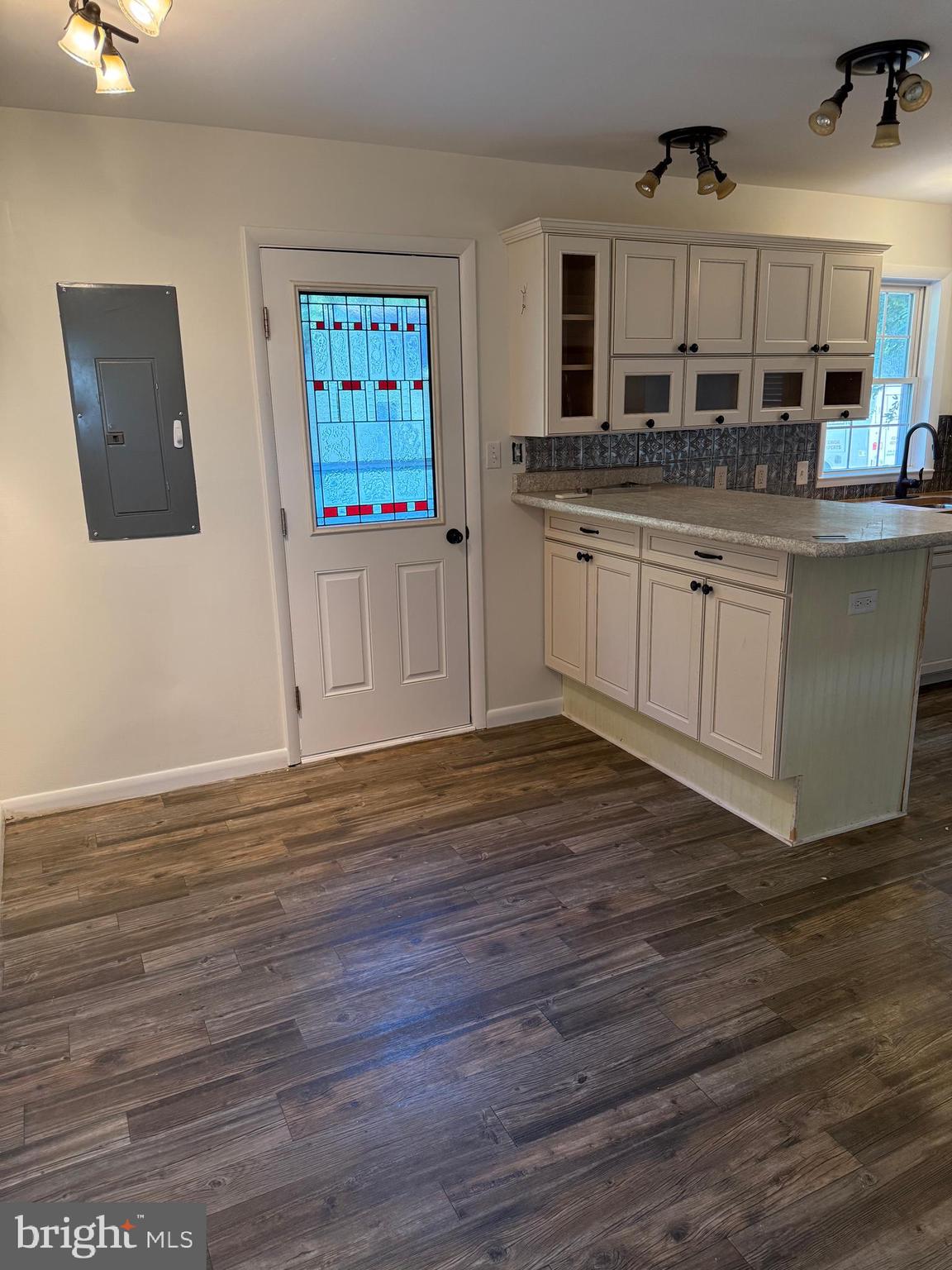 24975 Kruger Road Georgetown, DE 19947 - Photo 5 of 19 a kitchen with stainless steel appliances granite countertop a sink and cabinets with wooden floor