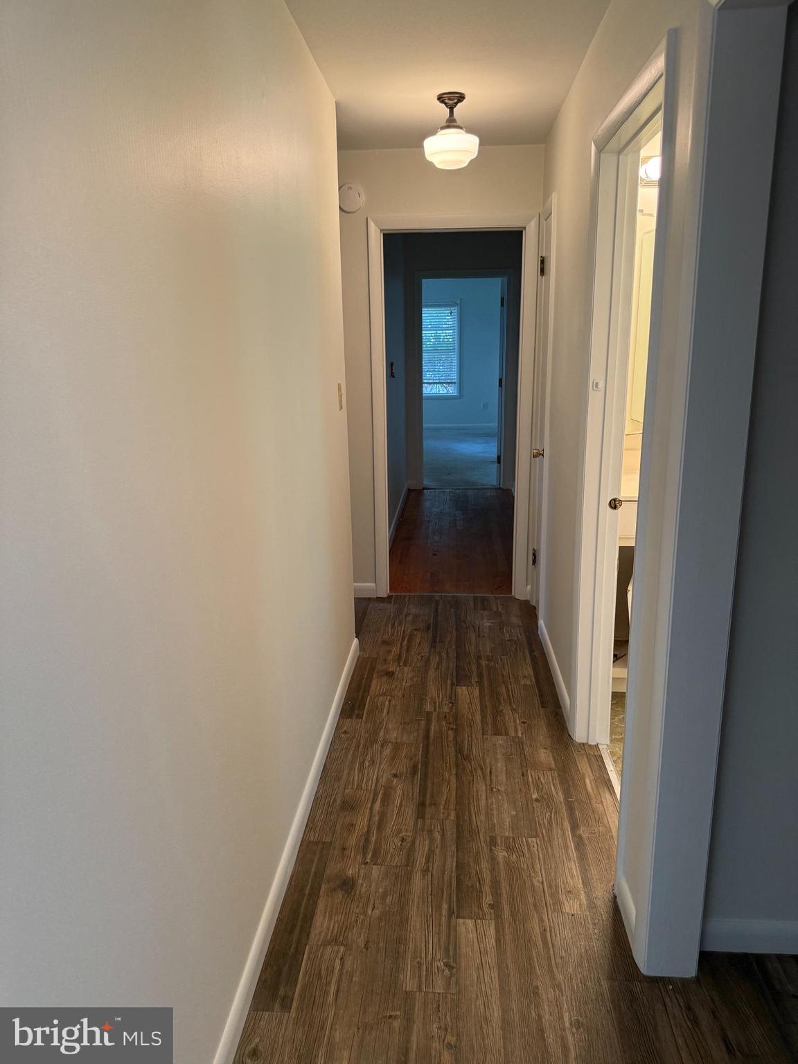 24975 Kruger Road Georgetown, DE 19947 - Photo 8 of 19 a view of a hallway with wooden floor