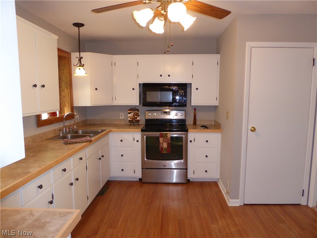9979 Wilson Mills Road Chardon, OH 44024 - Photo 11 of 35 Great Working Kitchen with Stove and Microwave and Recently Updated Ceramic Countertops and Cabinet Pulls and Accent Lighting!