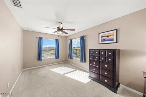 a bedroom with a bed and dresser with mirror
