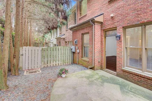 a view of a house with a wooden fence