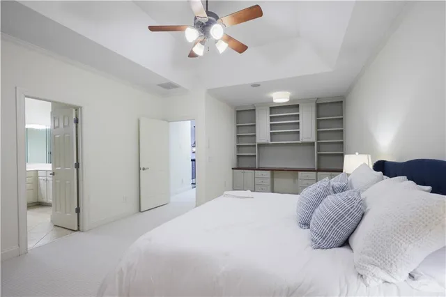 a bedroom with a large bed and a ceiling fan